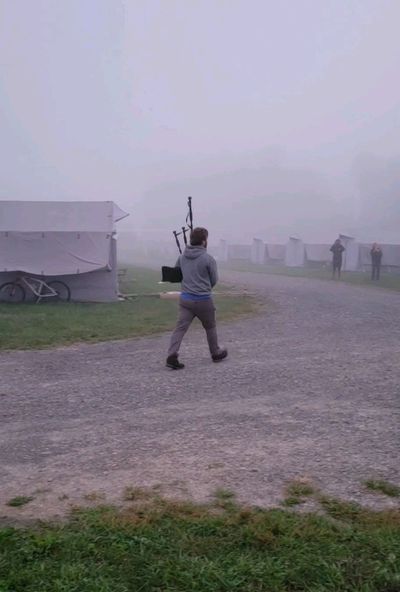 man playing bagpipes in the fog